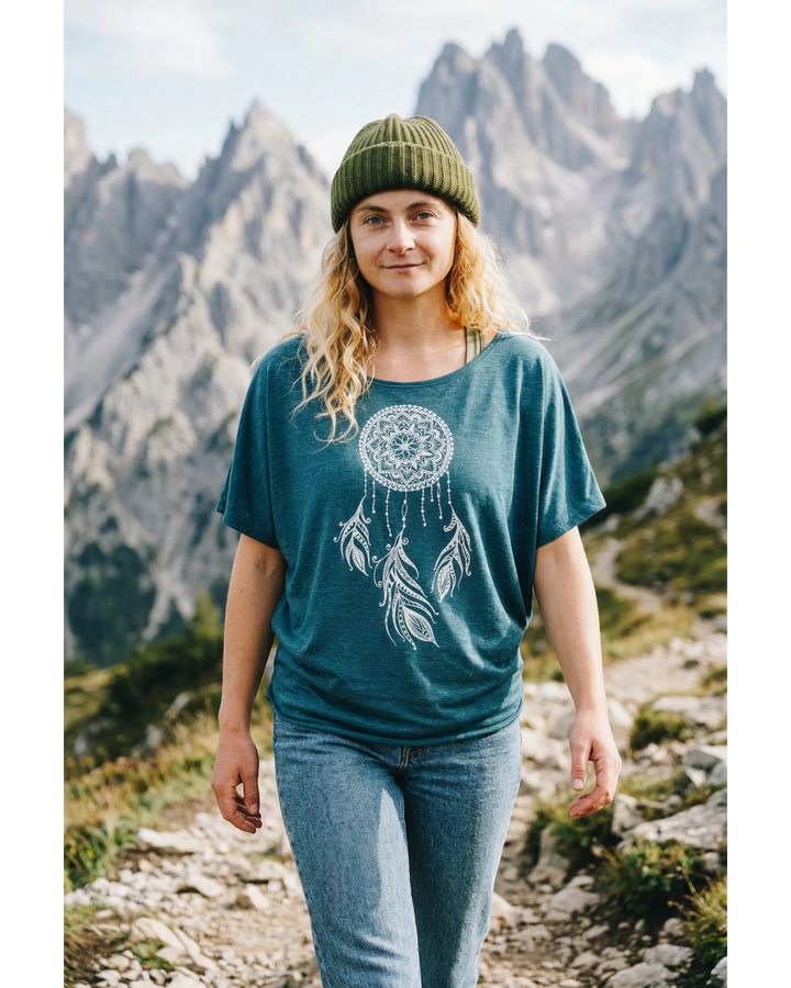 ULA turquoise batwing top with white dreamcatcher graphic print. Relaxed fit, short sleeves.